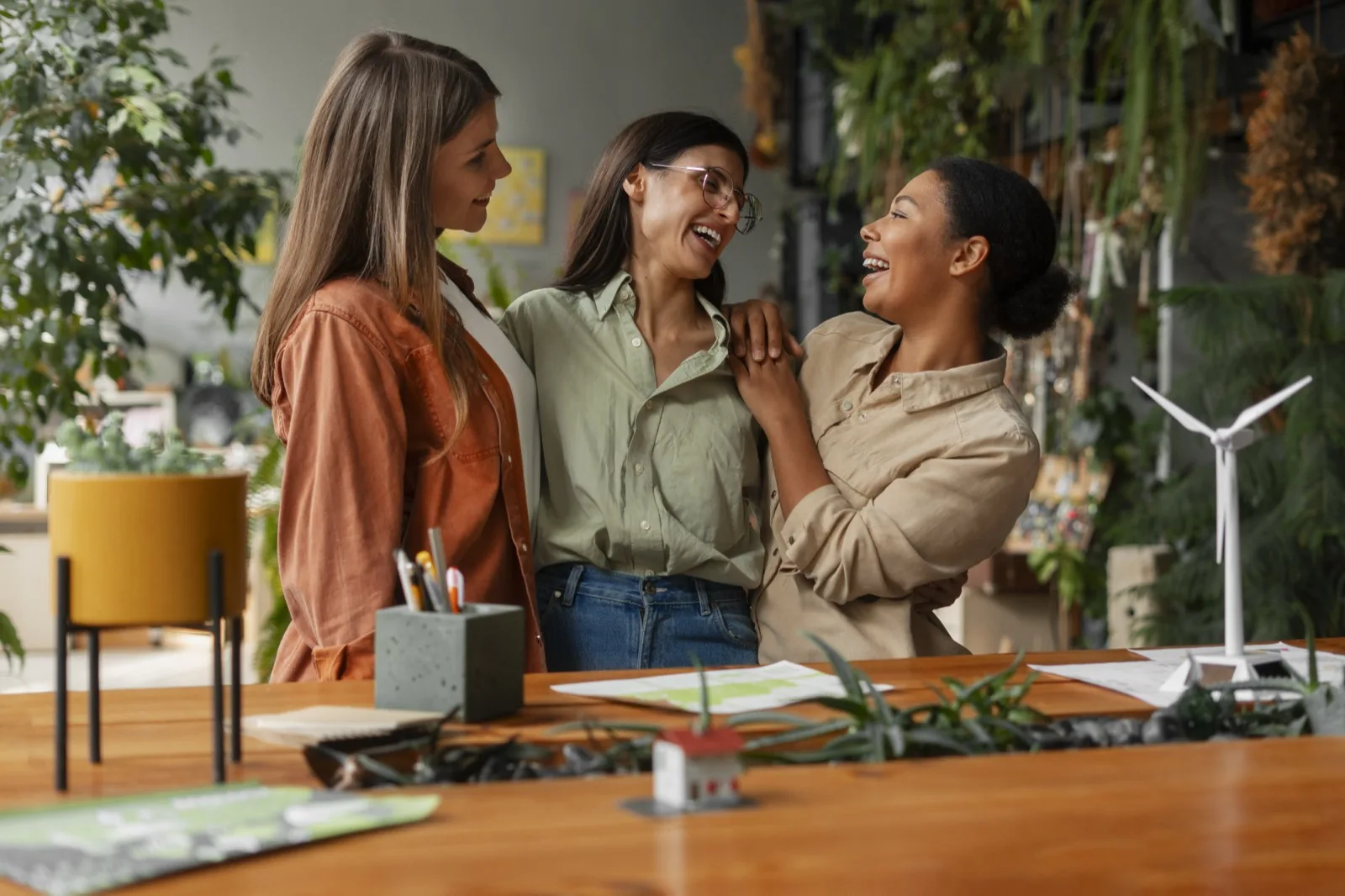 Women colleagues laughing together in an office